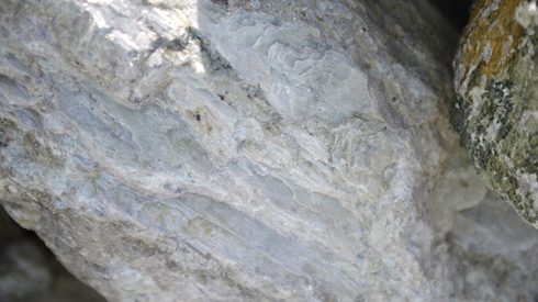 A rock containing spodumene, a lithium raw material, sits in a stockpile prior to crushing at a lithium mine site in Australia