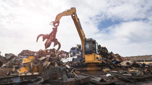 steel scrap prices - Crane loading steel scrap at steel scrap yard